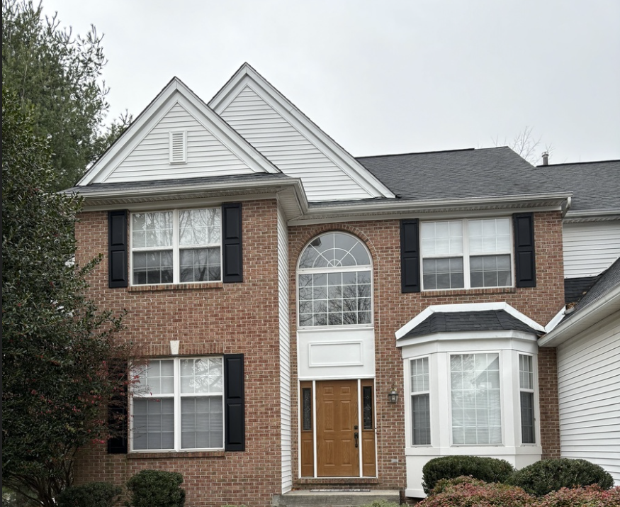 Home in Glen Mills PA with brick facade, partial siding and window shutters