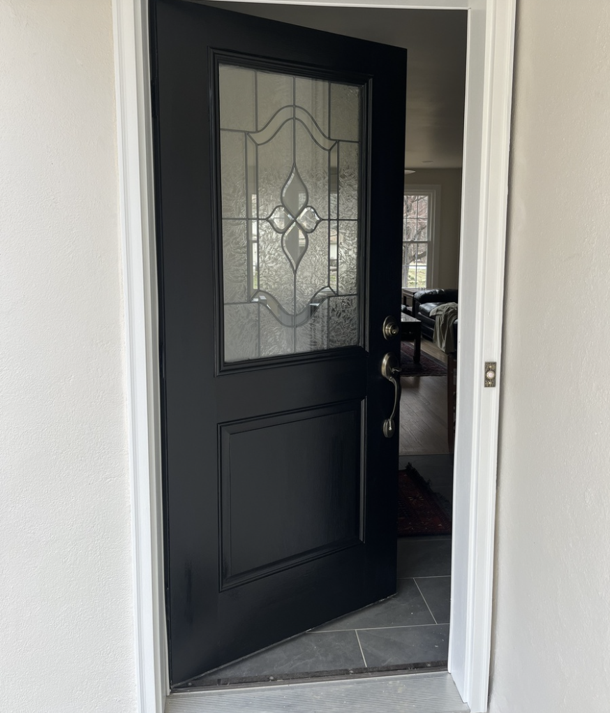 Entry door in a home in West Chester PA freshly painted in black with white trim