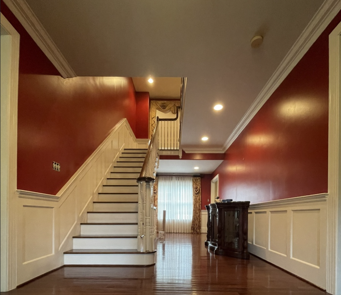 Historic home's entry way with red walls and white trim in Downingtown PA