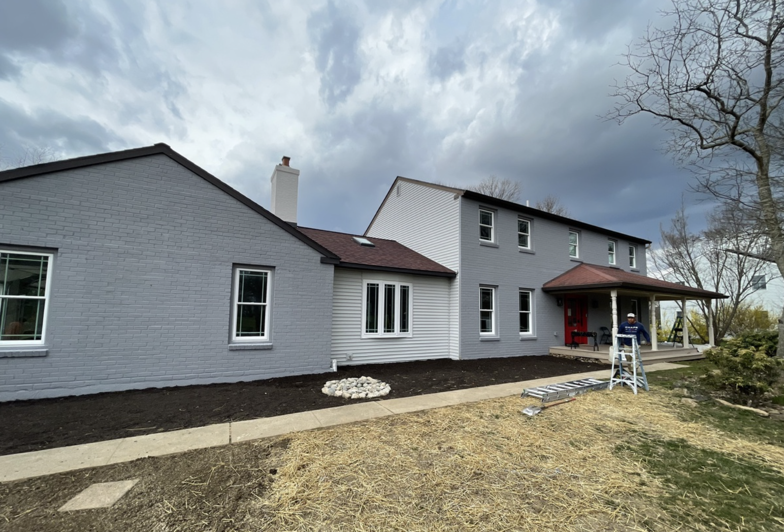 Split level residence with recent exterior paint job on brick and siding facade by Van Horn Painting