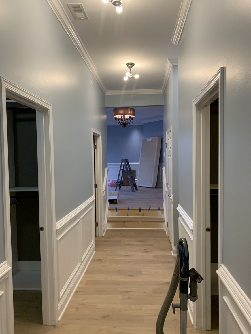 Hallway with fresh light blue paint after wallpaper removal