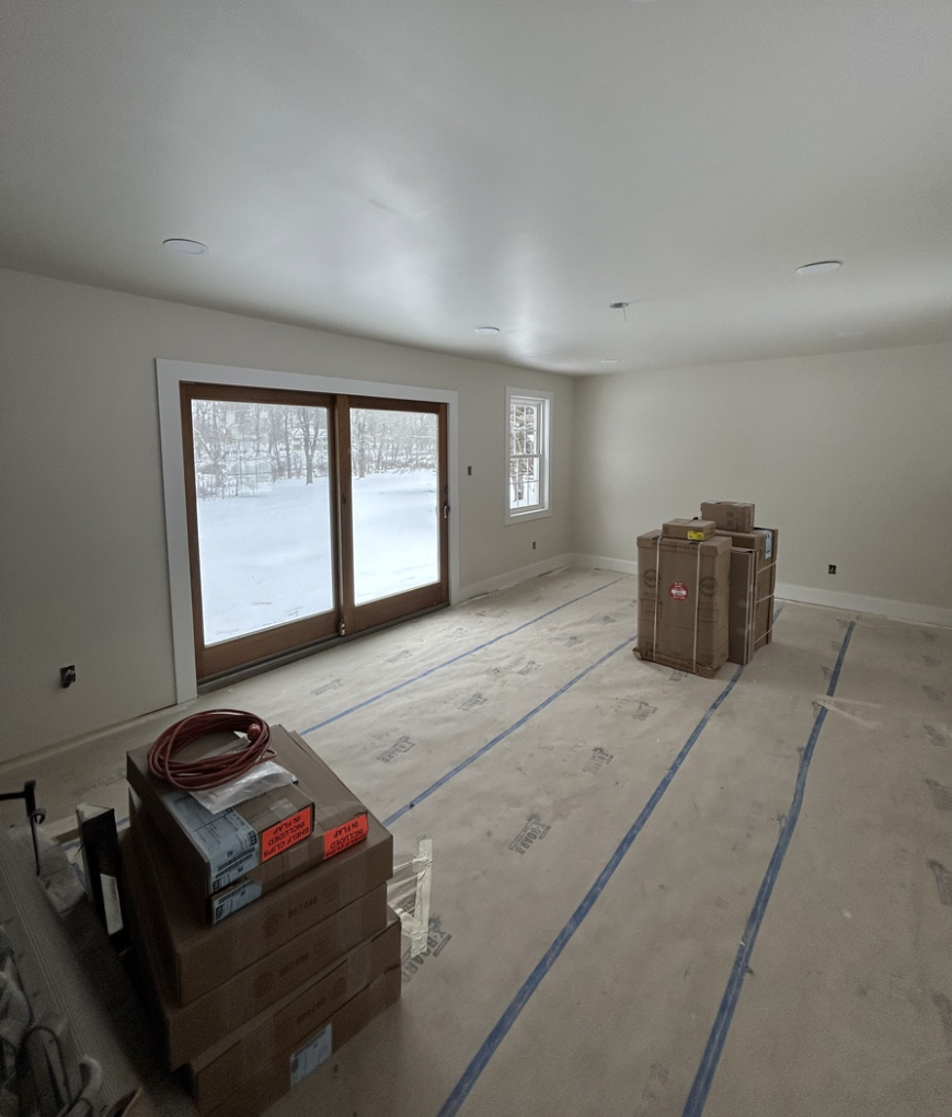 Home interior with floor covered in masking paper in prep for painting in West Chester PA