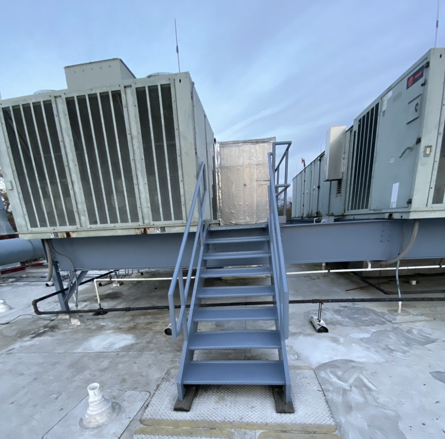 Rooftop metal stair case and steel HVAC platform support beams