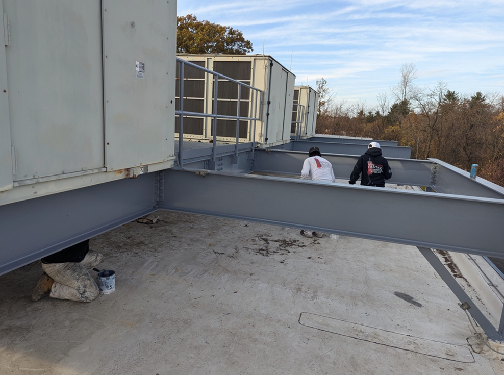 Van Horn Painting professionals on rooftop steel beam job site