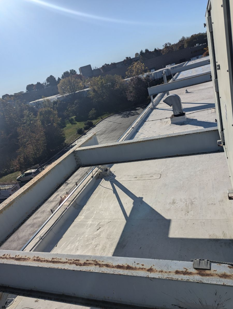 Steel beams on rooftop with rust in need to painting
