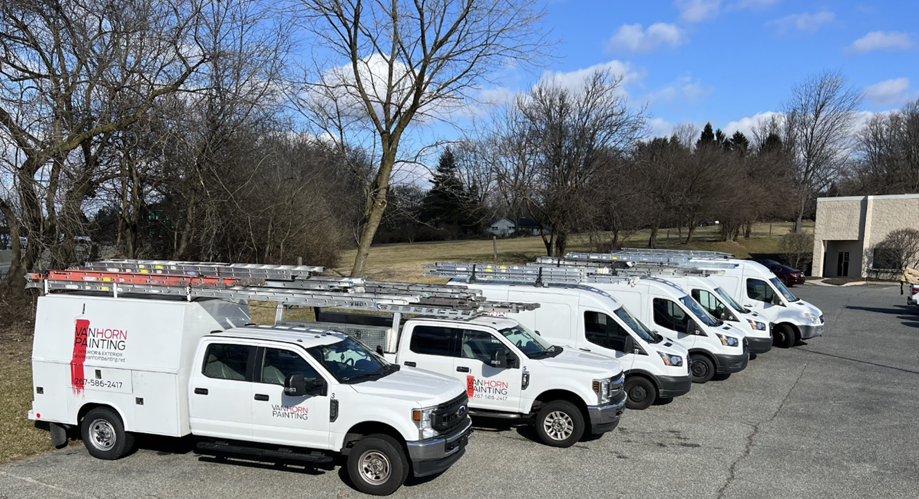 Van Horn Painting work trucks and vans lined up in parking lot