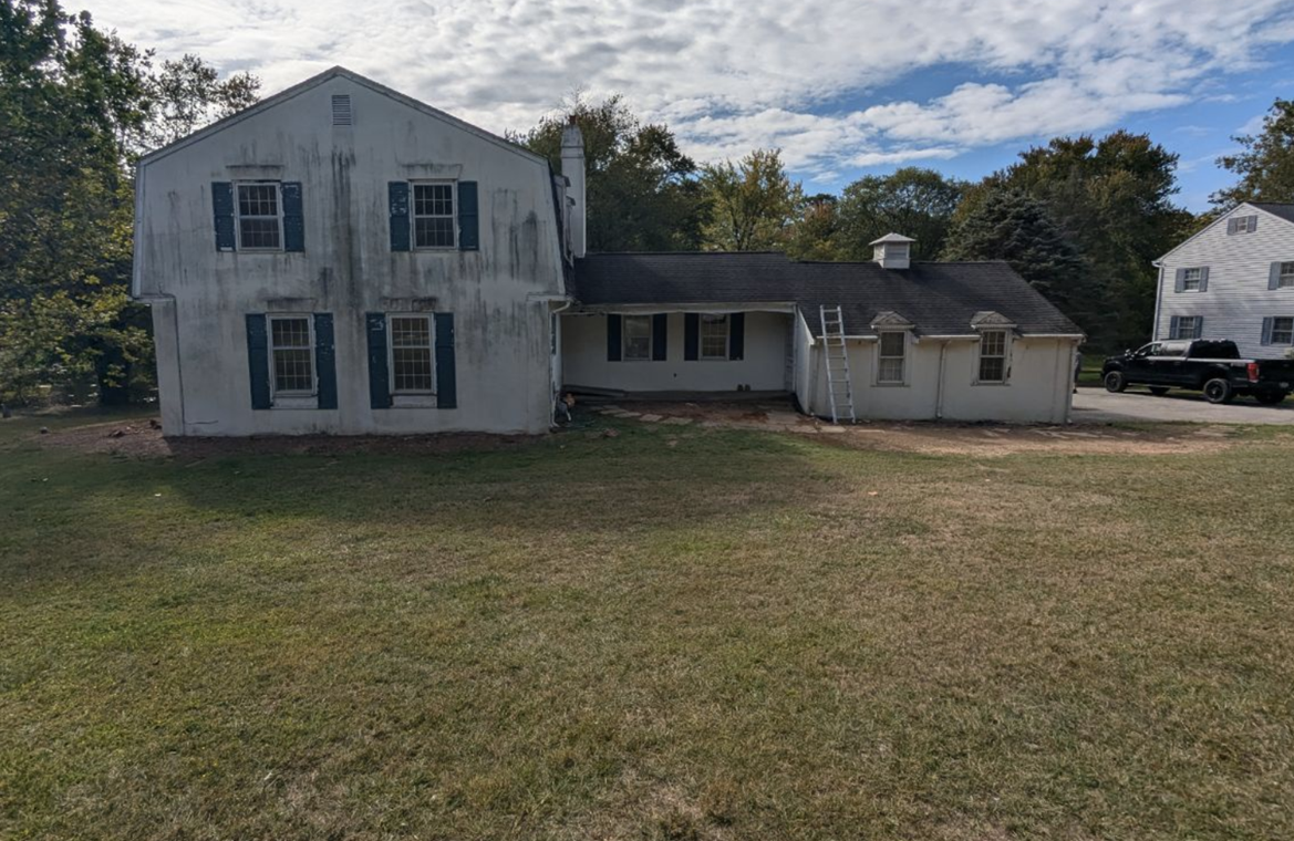 Exterior of a split level home showing aging paint in need of new paint in West Chester PA