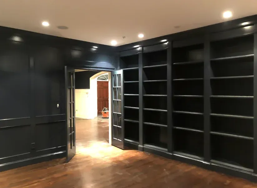 A room with a lot of shelves and a door