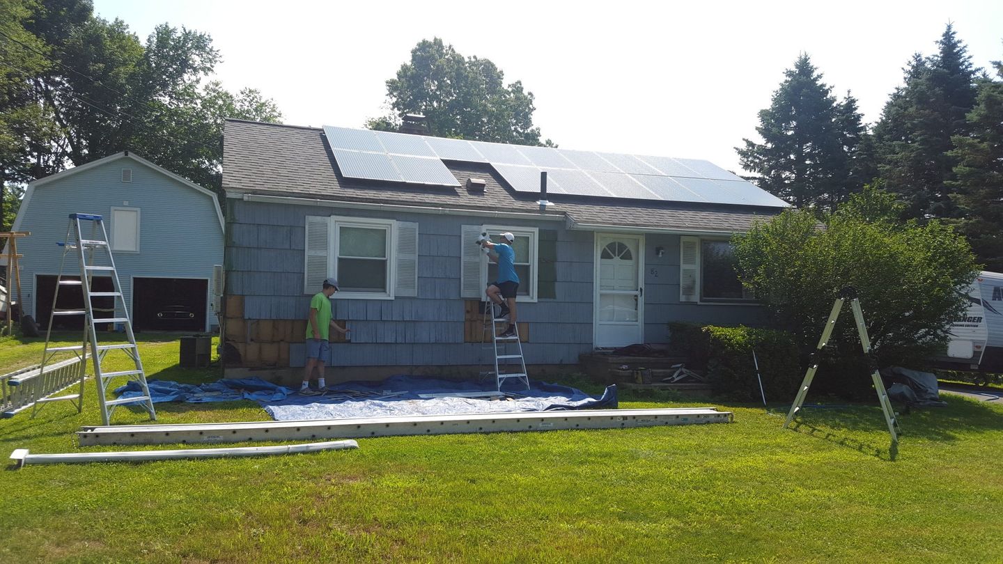 Wooden shake siding to be replaced is dried out, fading, and deteriorating altogether.