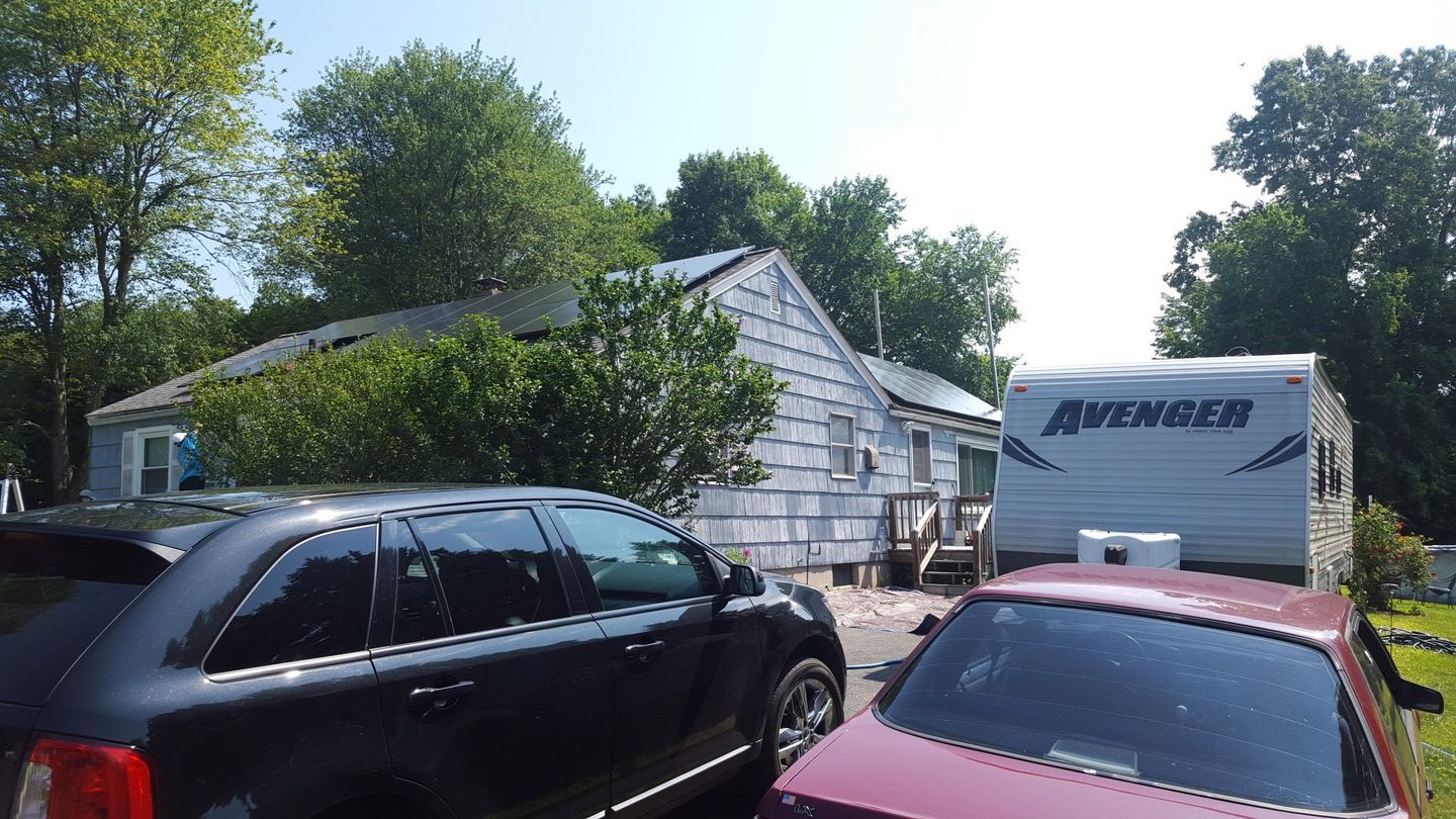 Wooden shake siding to be replaced is dried out, fading, and deteriorating altogether.