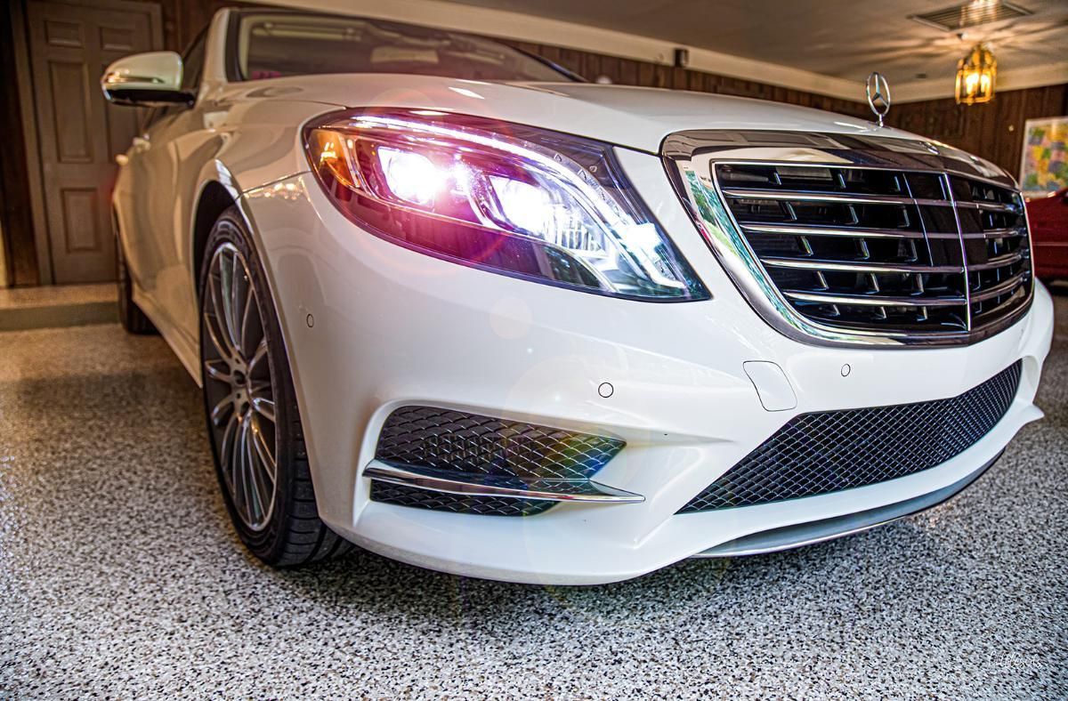 White luxury car in a garage with epoxy garage floor