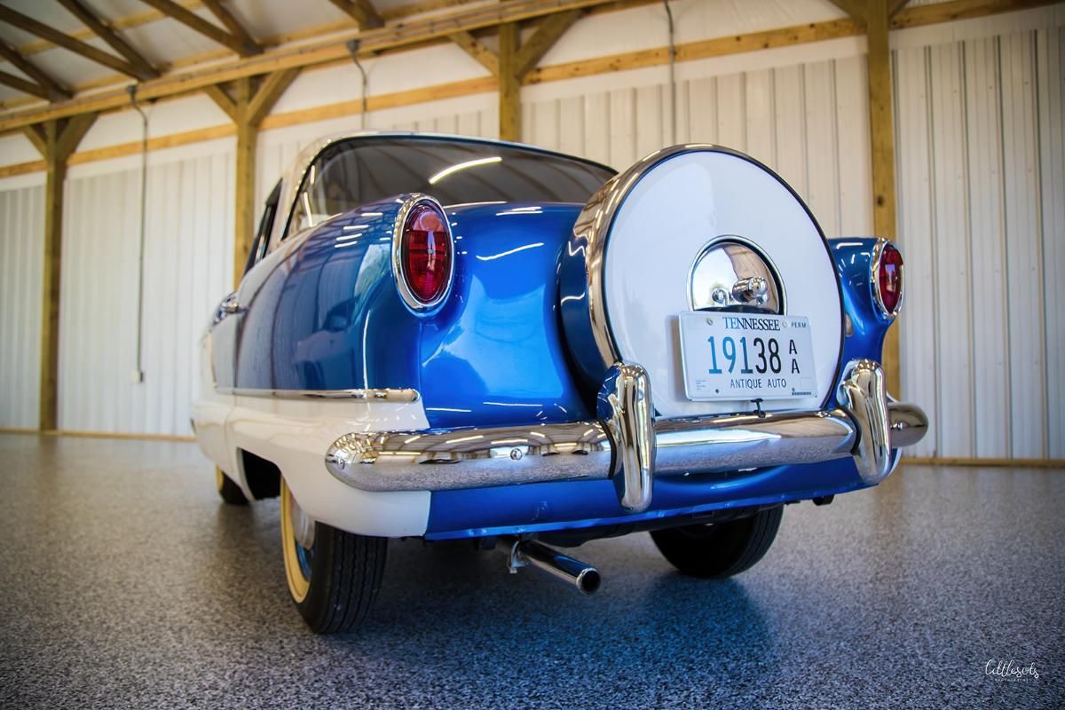 Blue and white classic car in a garage with epoxy garage floor