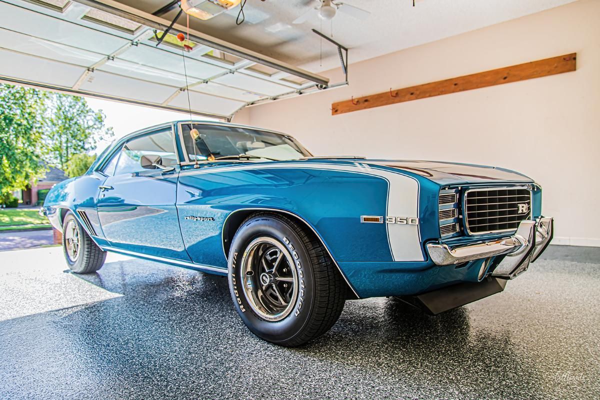 Blue classic car in a garage with epoxy garage floor