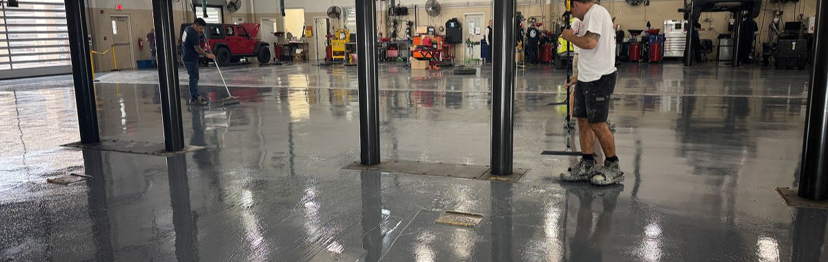 Person standing with a dog in a shiny indoor lobby or garage, with reflections on the wet floor.