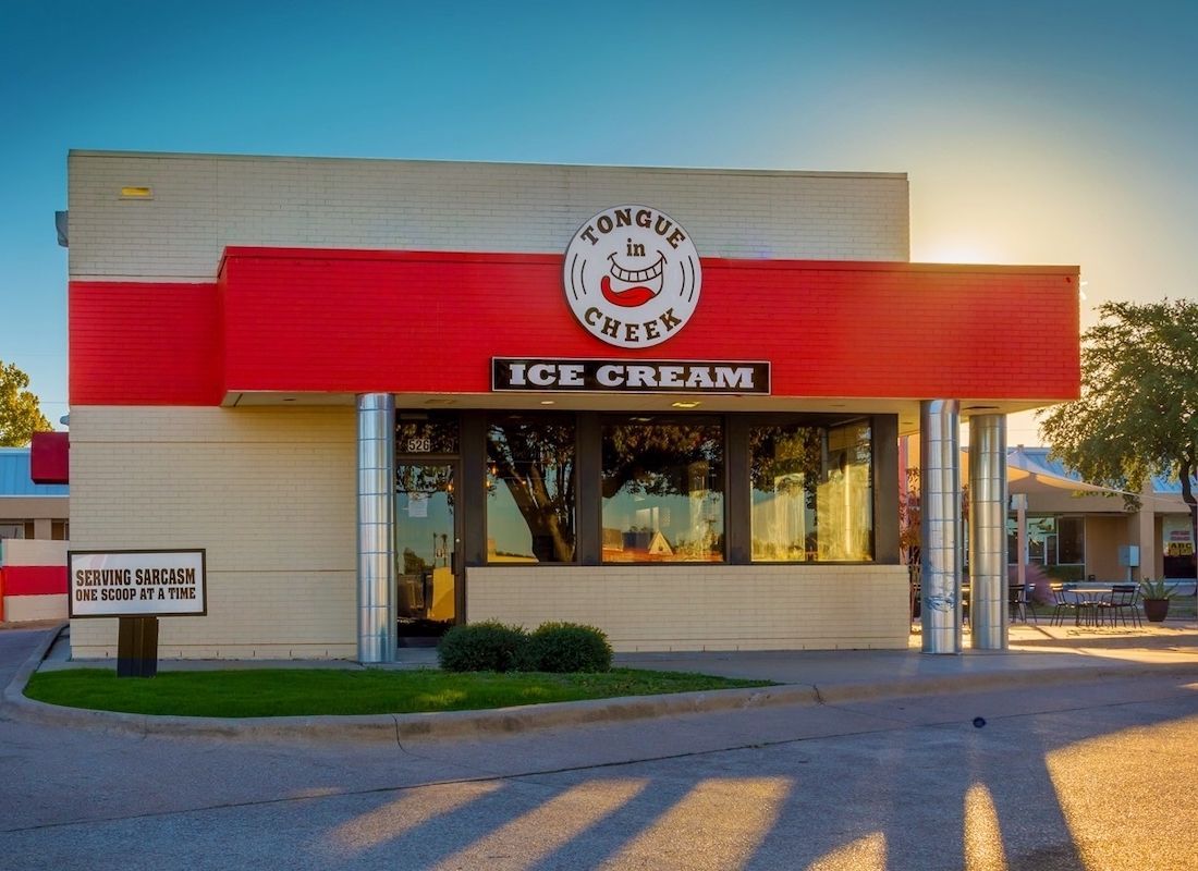 A red and white ice cream shop with a sign that says ice cream