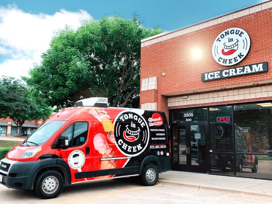 Red Truck in front of brown brick building with white circle logo