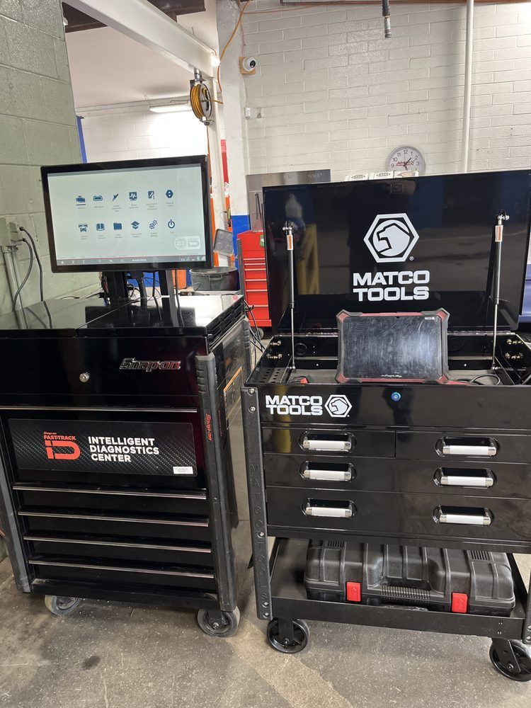 Auto shop with two black tool chests, a monitor on the left, and a Matco Tools cabinet on the right | Diamond Automotive