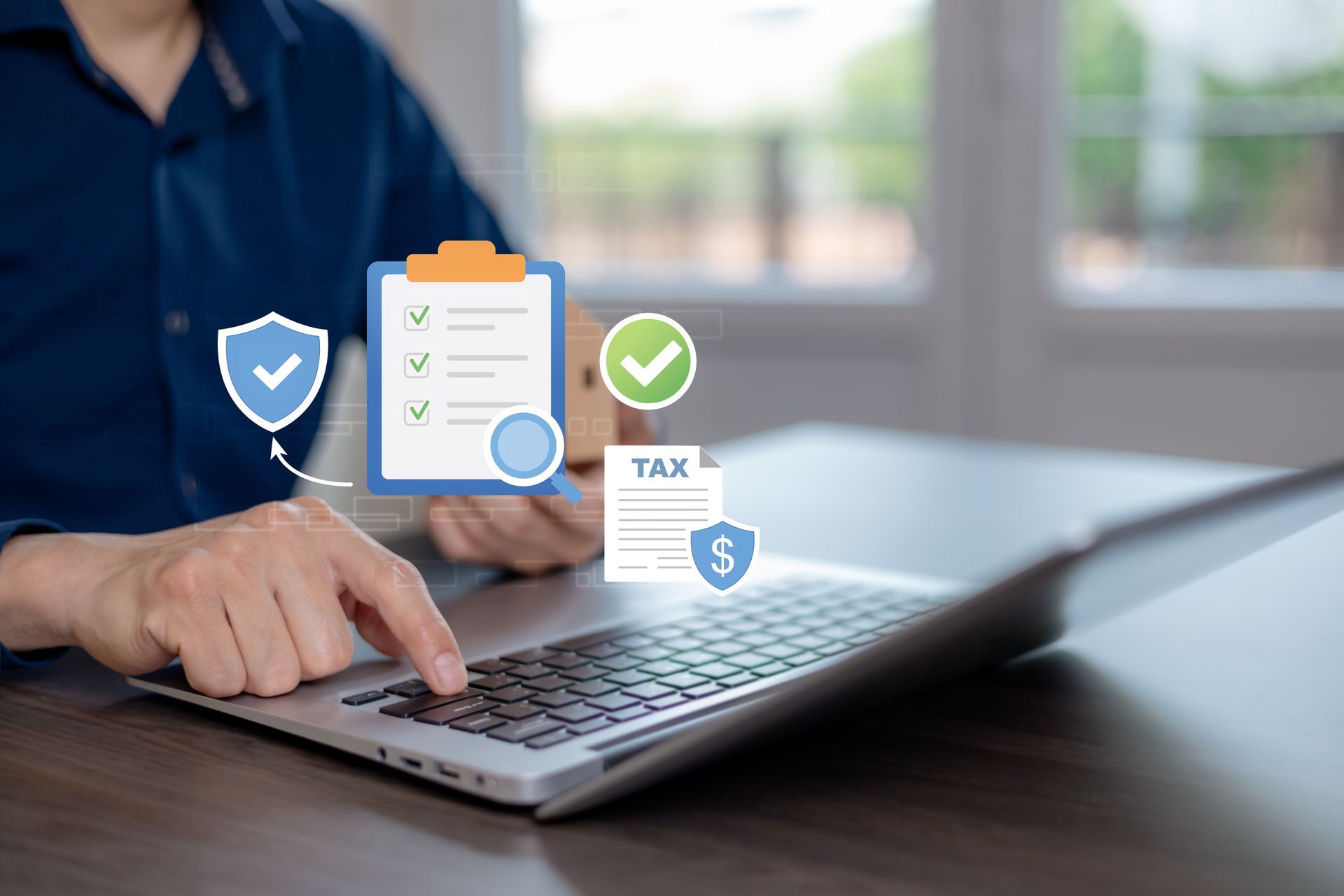 Person typing on laptop with floating tax, shield, and check icons in a bright office setting