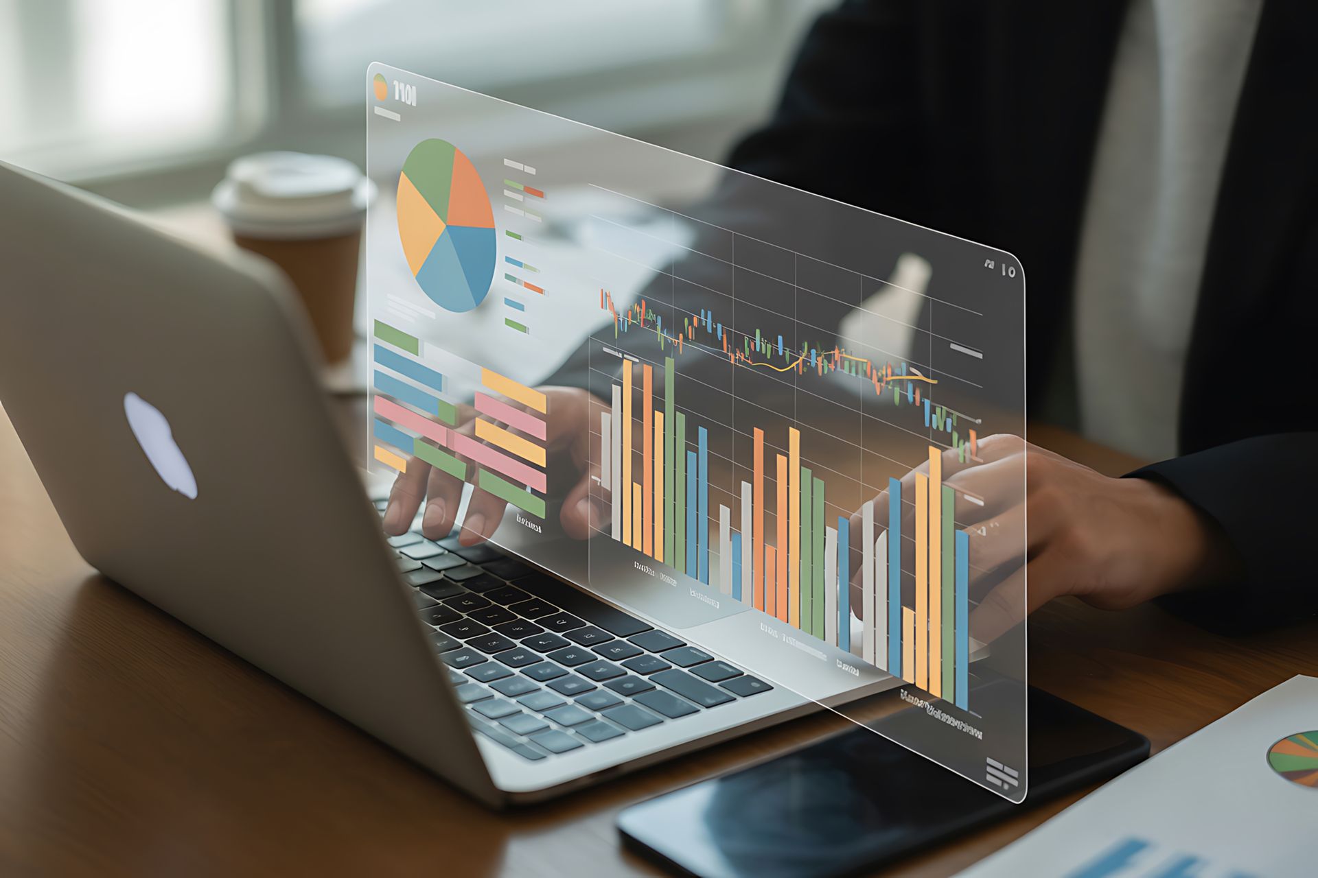 Laptop with transparent analytics charts and graphs hovering over the screen on a desk