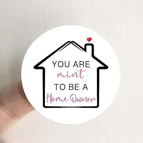 White round sticker with a black house outline and the words “You are mint to be a home owner.”