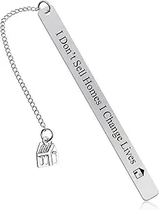 Silver keychain engraved “I Don’t Sell Homes I Change Lives” with a small house charm