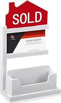 White countertop display stand with a red SOLD sign and brochure slots underneath