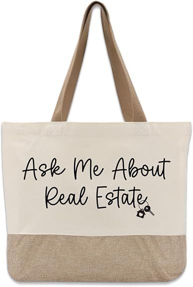 Canvas tote bag with “Ask Me About Real Estate” text in black and a tan bottom panel and handles