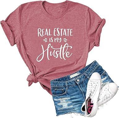 Mauve T-shirt reading “Real Estate is my Hustle” with denim shorts and white sneakers