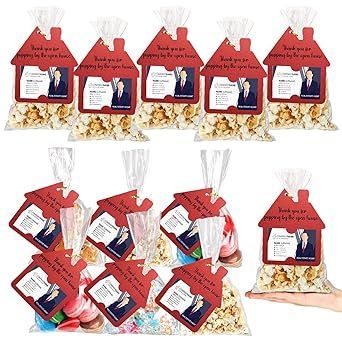 Assorted red gift-tag popcorn bags with photo labels, arranged in two rows on a white background