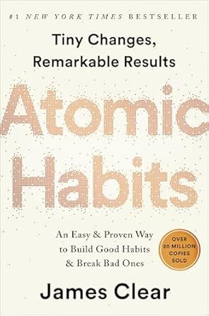 Book cover for Atomic Habits by James Clear, with beige background and large pale orange title text.