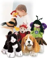 A child is playing with a bunch of stuffed animals.
