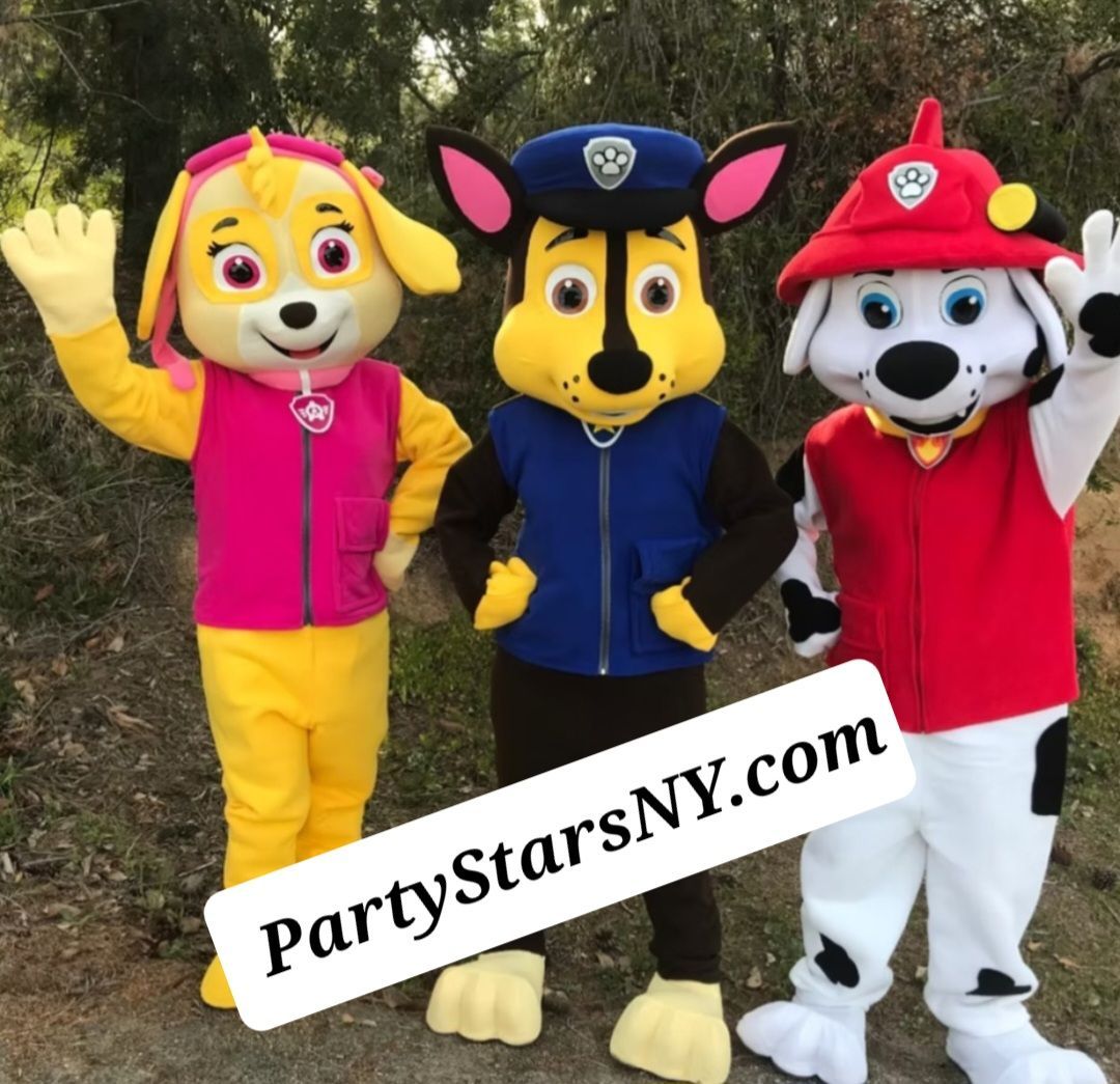 Three paw patrol mascots are standing next to each other