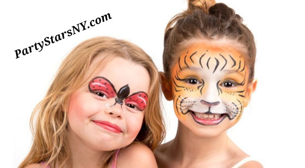 Two little girls with their faces painted in different animals.