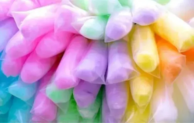 A bunch of colorful cotton candy bags stacked on top of each other