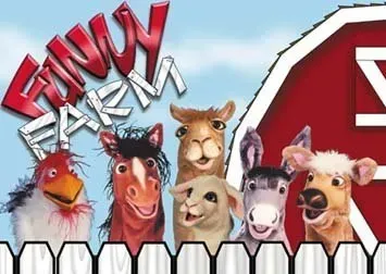 A group of farm animals standing in front of a red barn
