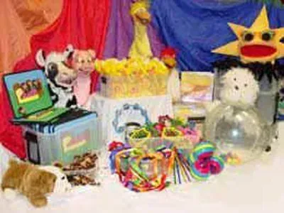 A table topped with lots of stuffed animals and toys.