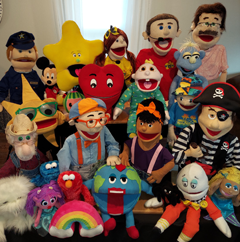 A group of stuffed animals including sesame street characters
