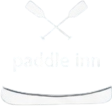 White bottle labeled “paddle inn” with two crossed paddles near the top.