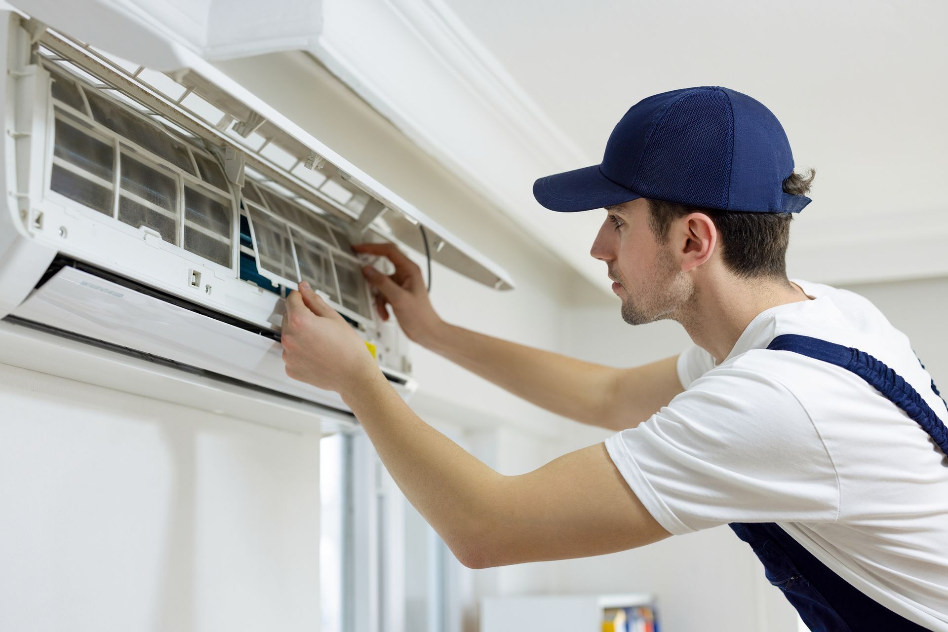 Air conditioning services technician repairing central air conditioner.