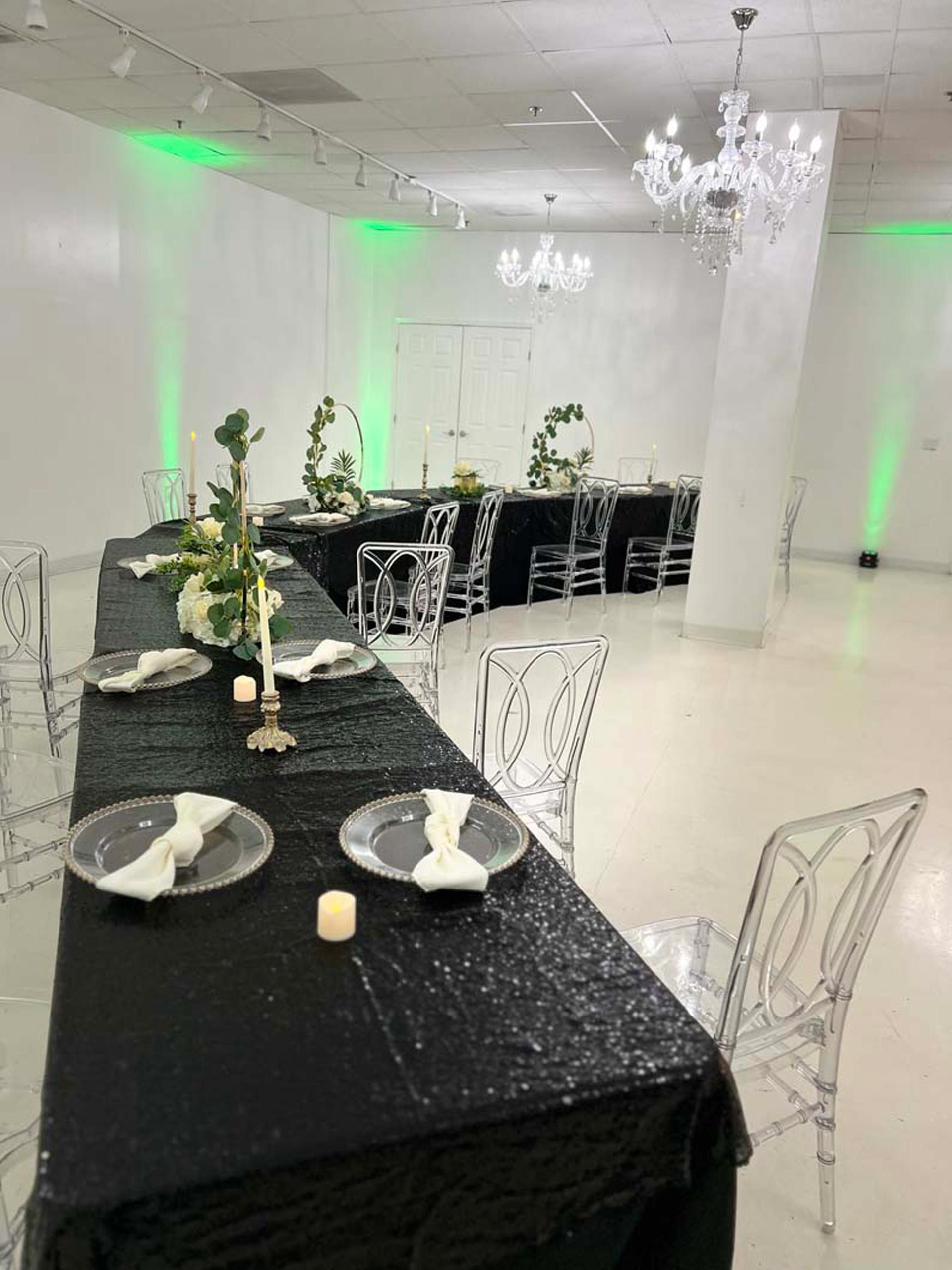 A long table with plates and candles on it in a room
