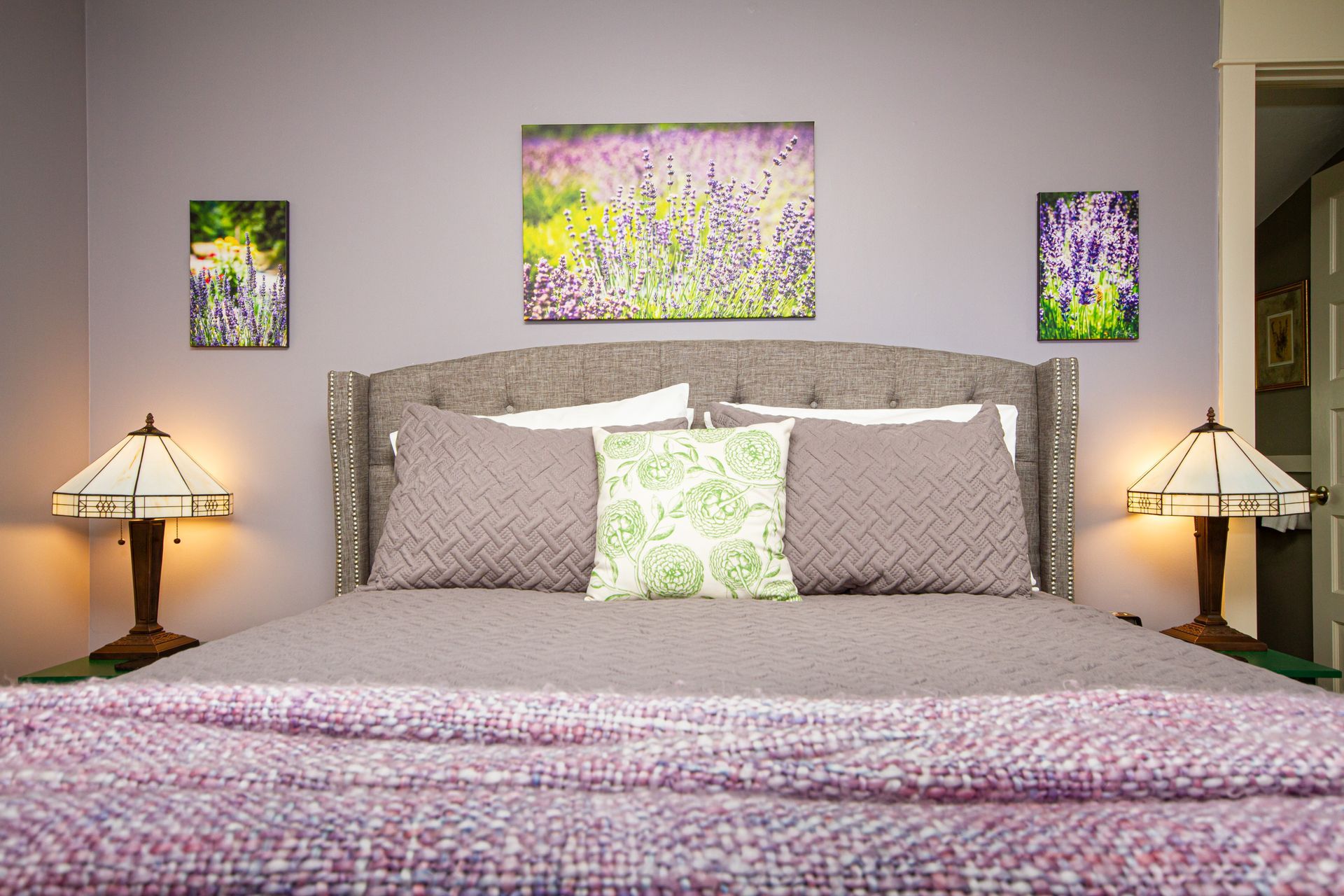 The Lavender Room showing the queen bed and table lamps.