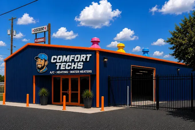 Comfort Techs storefront with blue building, orange trim, and a fenced entrance under a blue sky