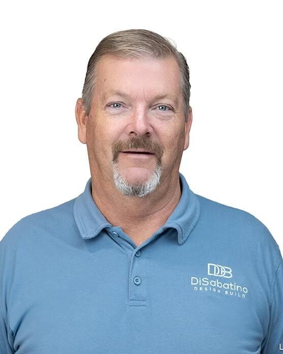 Man in light blue polo shirt with company logo, smiling against a white background