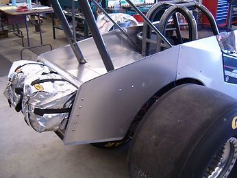 A race car with a bag on the back of it