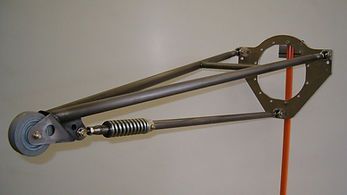 A close up of a metal object with a spring attached to it.