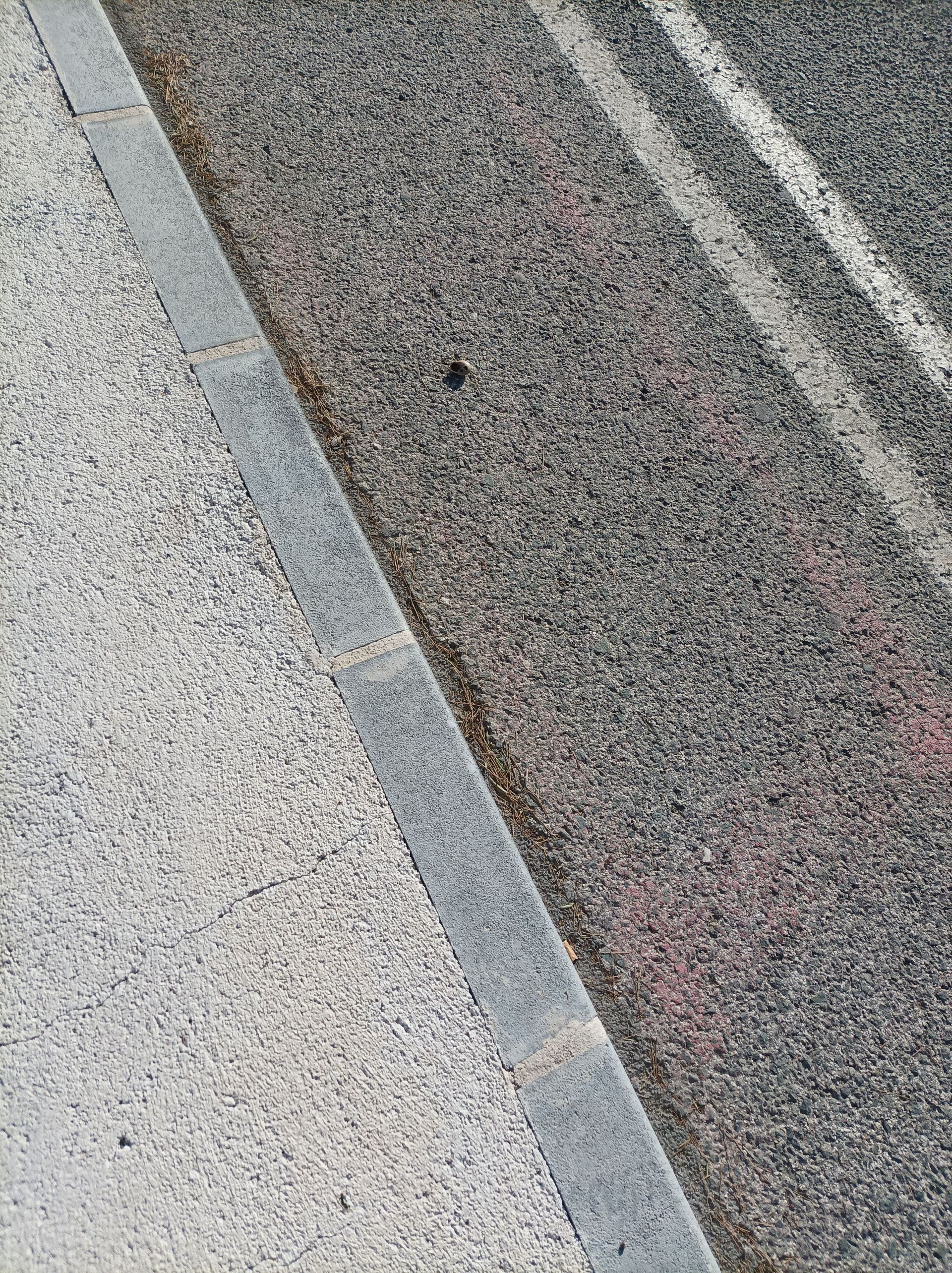 Close-up of a textured gray surface with diagonal light and dark stripes.