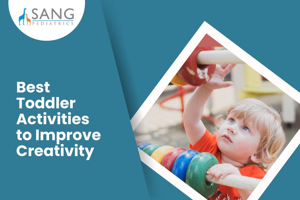 A toddler is playing with a rainbow colored toy.