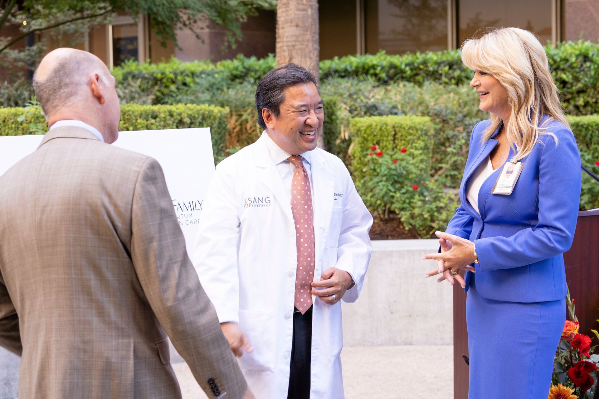 A group of people are standing next to each other and talking.