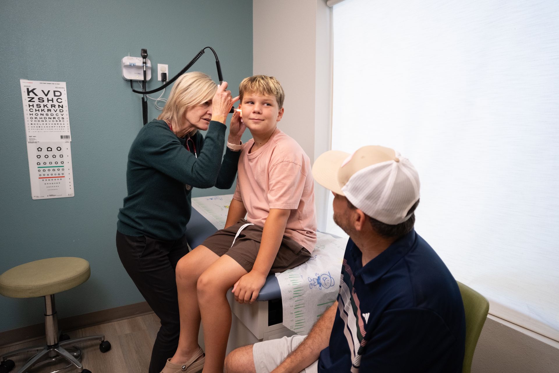 A young boy having his ear checked