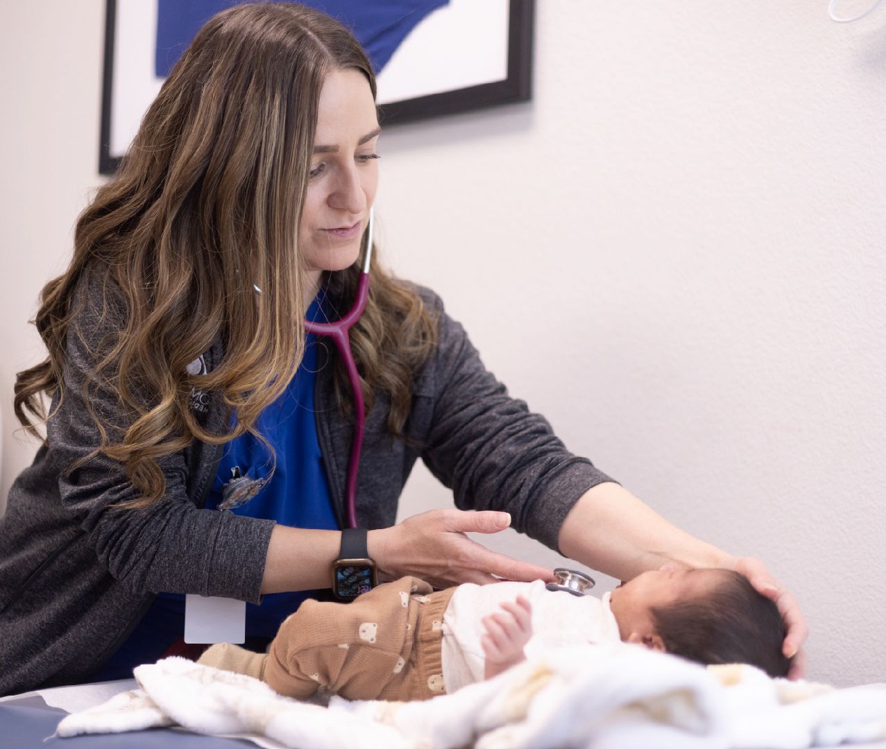 A woman checking a newborn baby